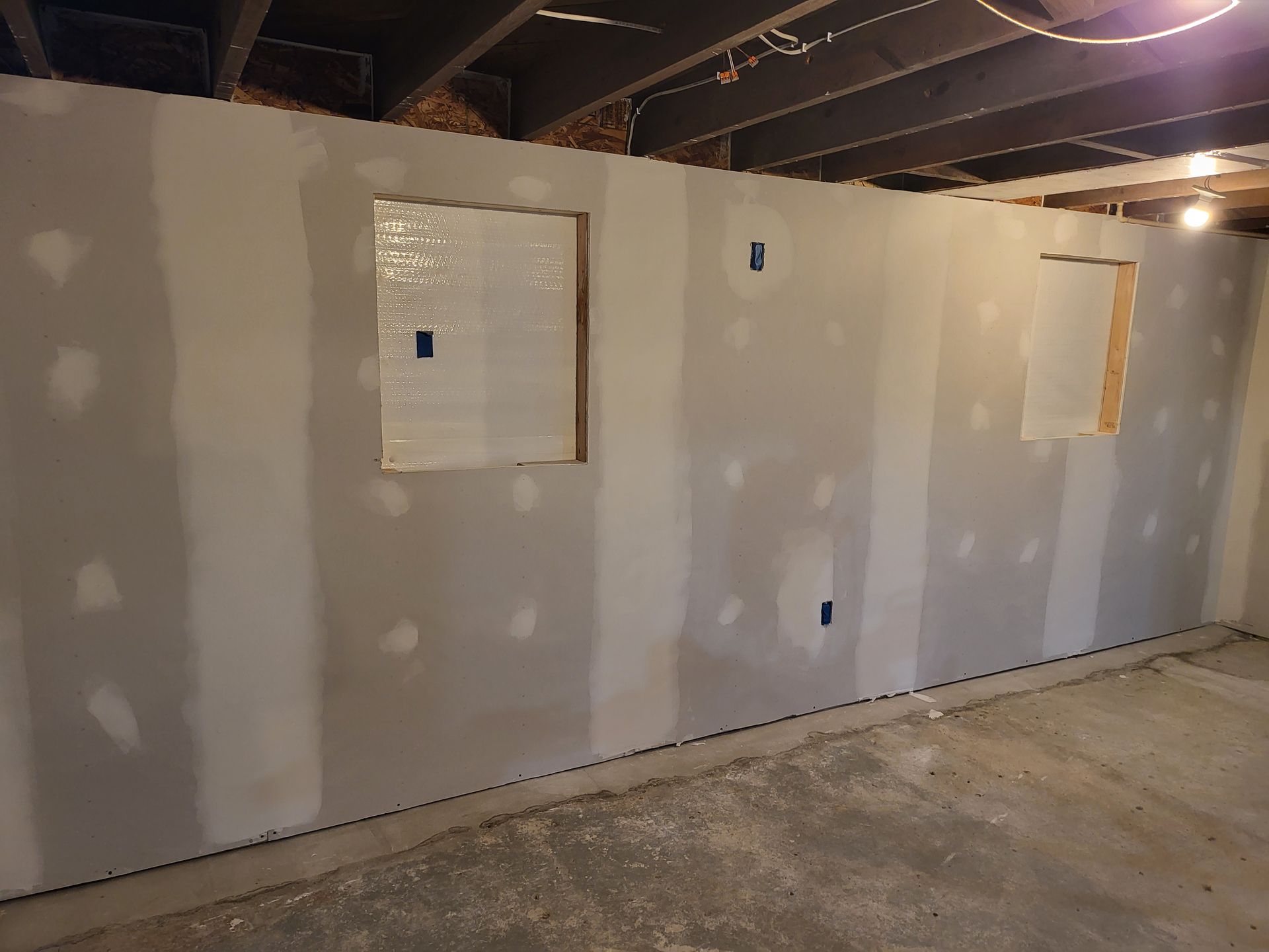 Basement under construction with drywall walls and framing