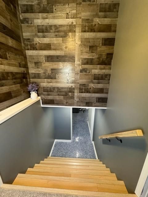 Wooden staircase leading to a finished basement