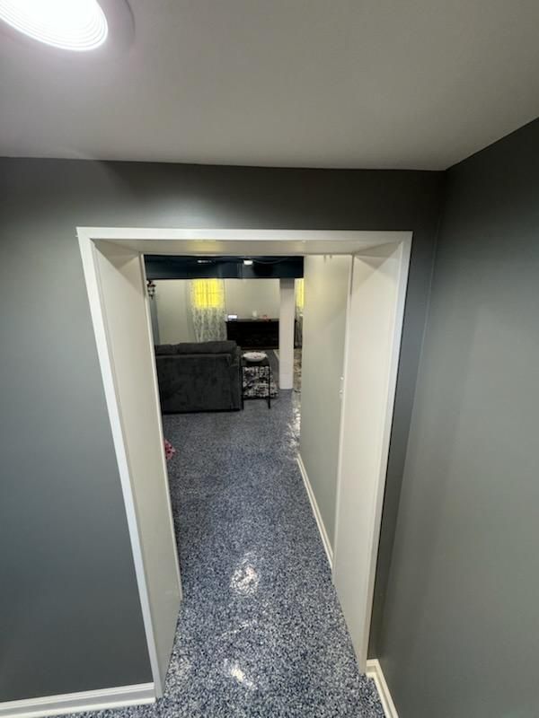 Hallway leading to a living room in a basement