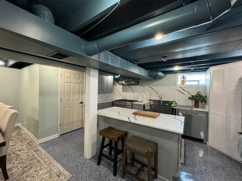 Basement kitchen with large island and stools