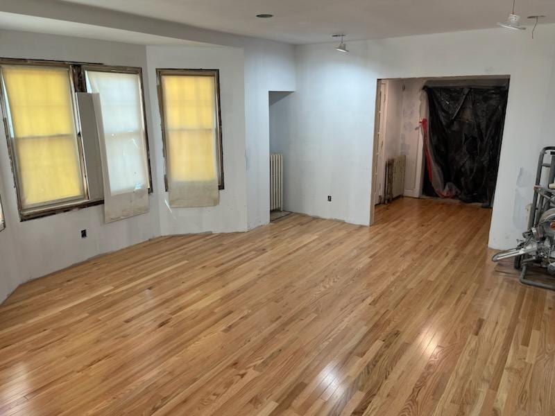 Hardwood floor refinish in progress in a renovated room