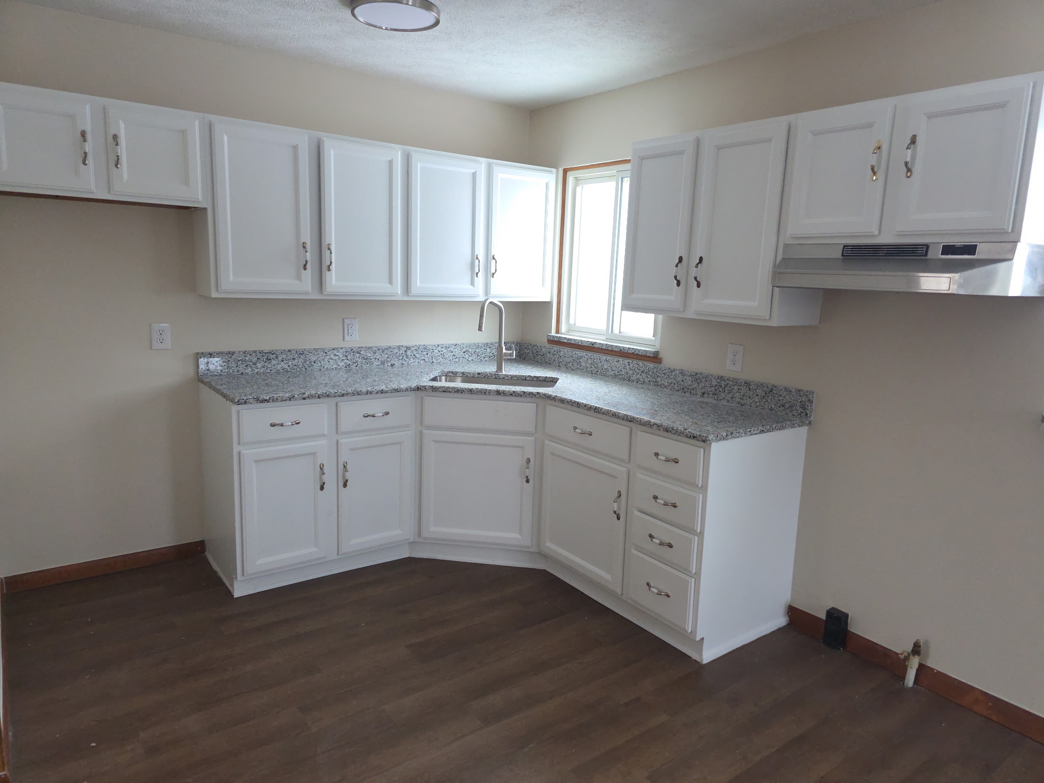 Finished custom kitchen with blue cabinets and a large island